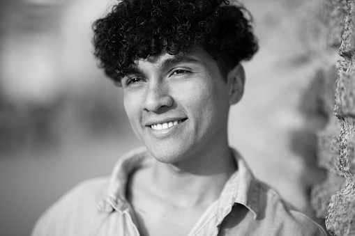 Close up black and white portrait smiling young man