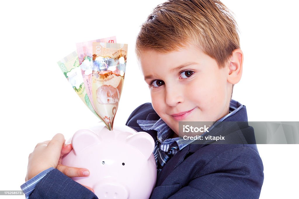 Mały chłopiec trzymać Świnka skarbonka z Kanadyjskie dolary - Zbiór zdjęć royalty-free (Dziecko)