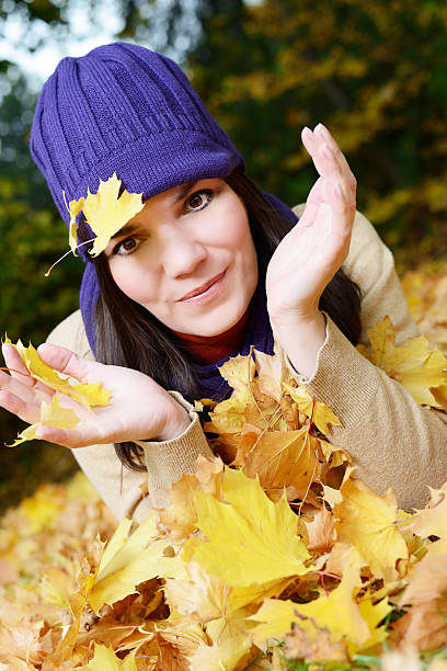 istock Young woman playing with leafs in autumn 175258777
