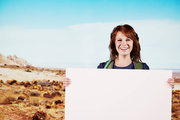 istock Woman with a placard in an arid area 175258915