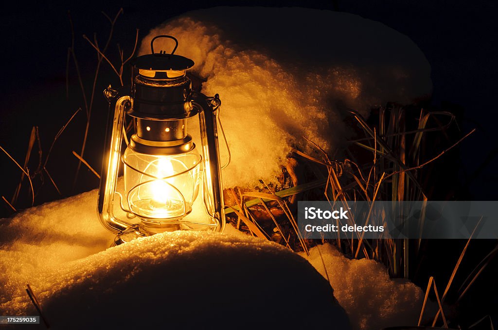 Warm oil lamps light in the snow Warm oil lamps light in the snow. Alloy Stock Photo