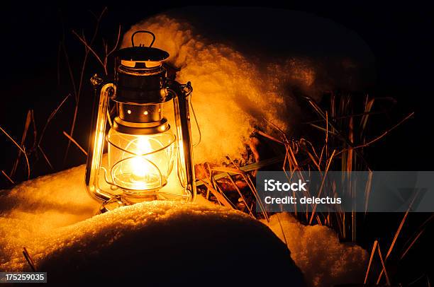 Warm Oil Lamps Light In The Snow Stock Photo - Download Image Now - Alloy, Burning, Crude Oil
