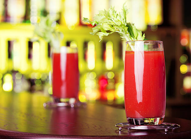 fresh tomato juice with celery in glasses, closeup horizontal