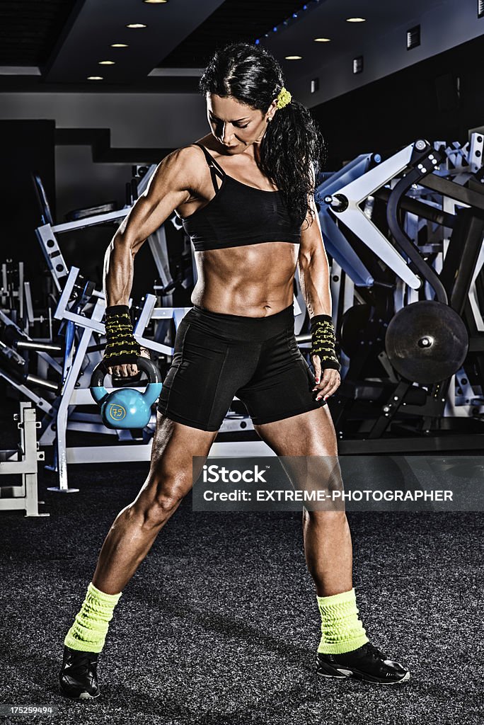 Female bodybuilder Muscular woman in the gym exercising with kettlebell. Active Lifestyle Stock Photo