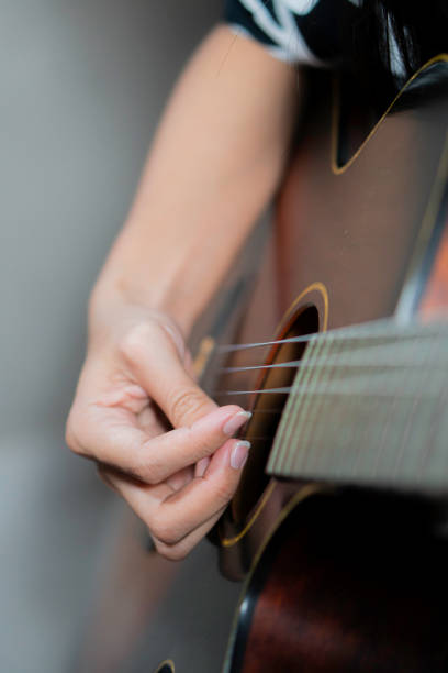 istock Young women playing acoustic guitar 1752599093