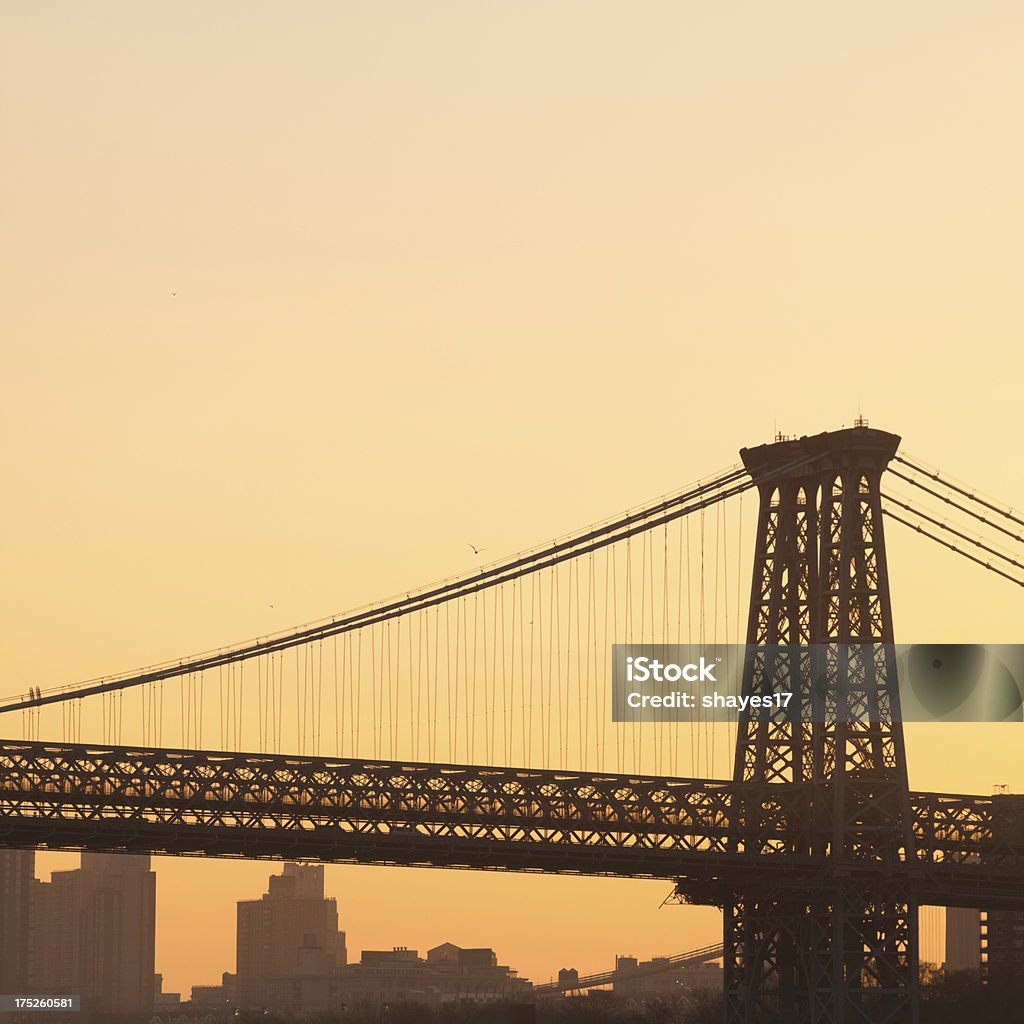 Williamsburg Bridge sunset A view of one of the towers of the Williamsburg Bridge with Brooklyn in the background taken at sunset. Back Lit Stock Photo