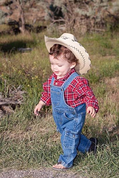 istock Little Boy Outdoors in Blue Denim Overalls and Cowboy Hat 175260681