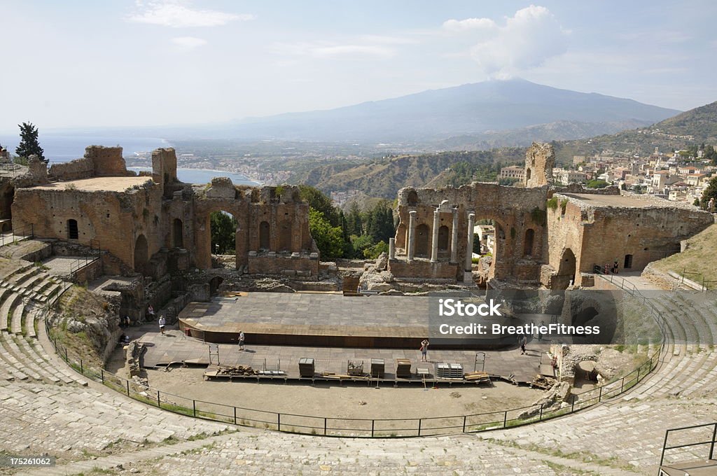 Taormina "View of the Greek Amphitheater and Mount Etna in Taormina, Sicily." Mt. Etna Stock Photo