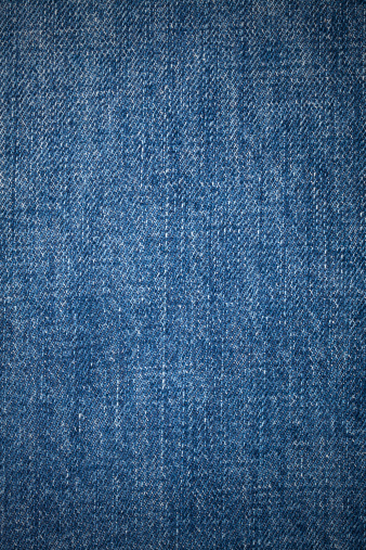 Close-up of denim cloth with vignette effect.