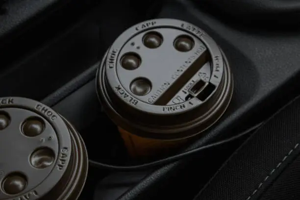 Photo of two coffees are in the car