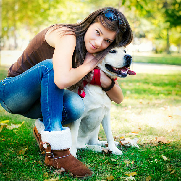 Close-up of a beautiful girl with her  labrador dog.