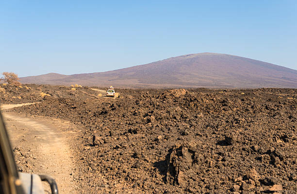 Over the lava field "Driving over the lava field in Africa's Danakil Desert. It is cruelest place on earth with baking temperatures, wastelands of salt, no trees and some very salty water. Only volcanic rocks, sand and salt." dallol ethiopia stock pictures, royalty-free photos & images