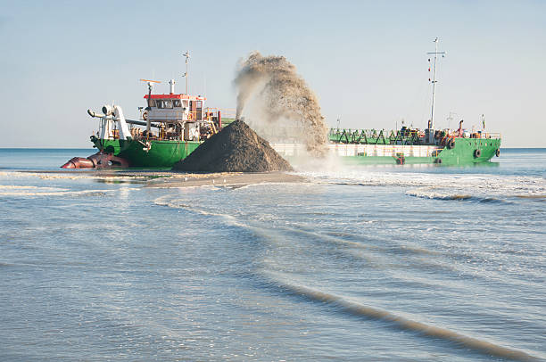 Dredge in action on the river stock photo