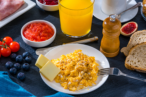 Tasty breakfast of scrambled eggs and fruit juice