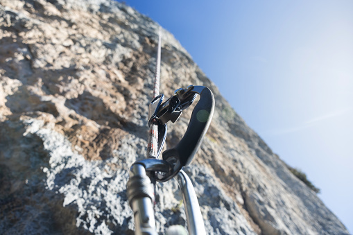 Close-up of hand ascender and climbing rope. Safety climbing equipment.