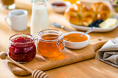 Sweet food. Jars of jam and honeyon breakfast table