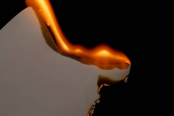 istock burning paper, glowing edge of paper on a black background 1752622073