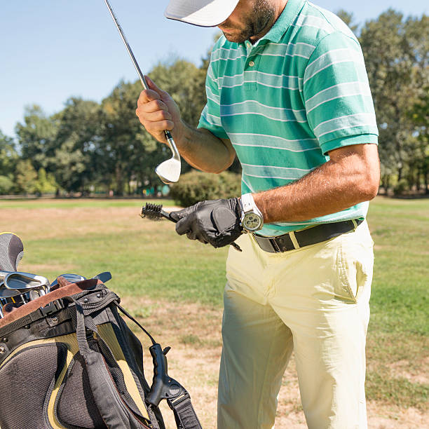 istock Golfer cleaning a club 175262447