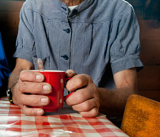 istock hands of mature men holding a cup with coffee 175262548