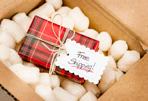 Christmas package in mailing box with free shipping label
