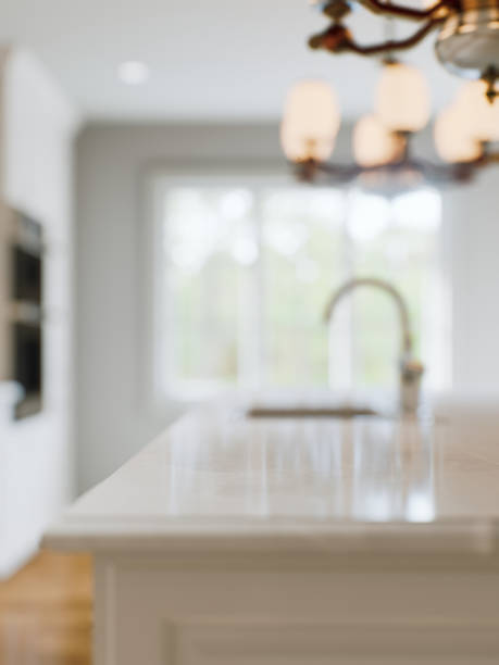 istock Kitchen white countertop with white marble, with blurred bokeh background. Presentation of goods in the kitchen interior on the countertop surface. 3D rendering 1752629881