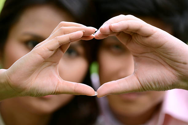 istock Heart shape of love from couple hands 175263576