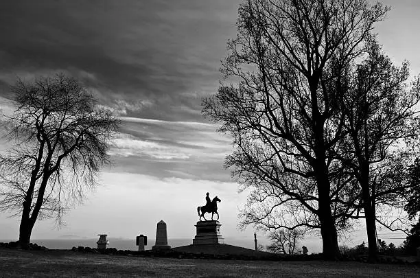 "A late afternoon scene on top of the historic East Cemetery Hill overlooking one site of the July 1863 battles of Gettysburg that took place during the American Civil War in Pennsylvania, USA. Monuments to General W.S. Hancock, the 1st Pennsylvania Light Artillery, Battery B, the 14th Indiana and 4th Ohio Regiments are seen in this part of Gettysburg National Military Park.Gettysburg Civil War Battlefield Memorials, scenes & National Cemetery:"