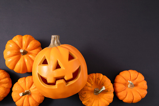 Halloween pumpkin head jack lantern with burning candles isolated on white background