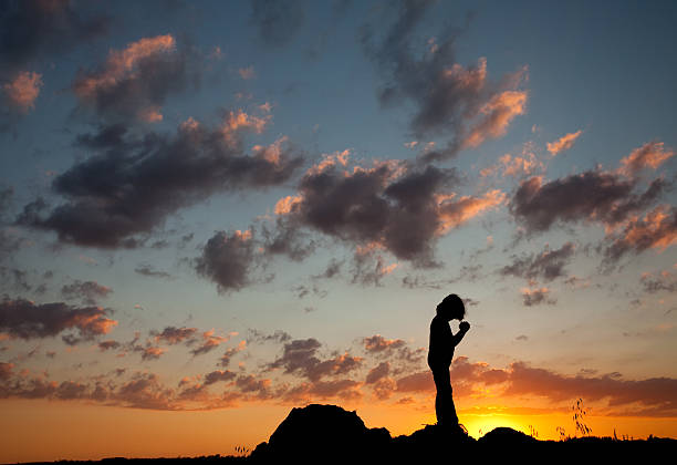 istock Silhouette of Young Boy Praying 175264029
