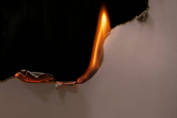 istock burning paper, glowing edge of paper on a black background 1752641844