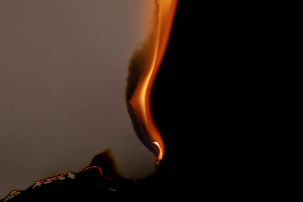 istock burning paper, glowing edge of paper on a black background 1752641878