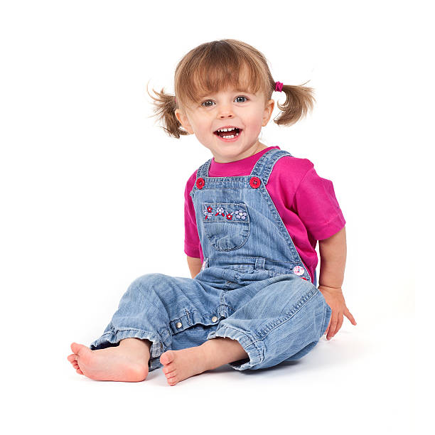 Small cute girl with pigtails on white background stock photo