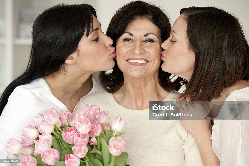 Figlia bacia per la Festa della mamma - Foto stock royalty-free di Abbracciare una persona