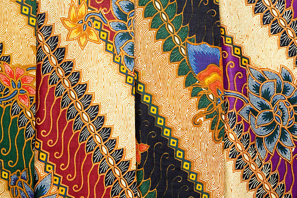 Printed Batik at Indonesian Textile-Market "Cheap printed batik at an Indonesian textile market in Ubud. Even cheap material has the typical colourful charm of indonesian textile. In the social and religious lives of Indonesians textiles are very important. Printed and handpainted batik are just two of a large variety of techniques. The symbolism of the various ethnic groups is evident in the variety of textiles. Color, shapes and their arrangements all have special meanings. Certain designs can only be worn by women or men, or only by the members of the royal family or nobility.Special textiles are worn or exchanged in life cycle or rights of passage ceremonies celebrating birth, circumcision, puberty, marriage, childbearing and death. Textiles play an important role in many traditional events and ceremonies. Among non oil or gas industries the textile and apparel industry is the largest export earner.My other photos of" batik indonesia stock pictures, royalty-free photos & images