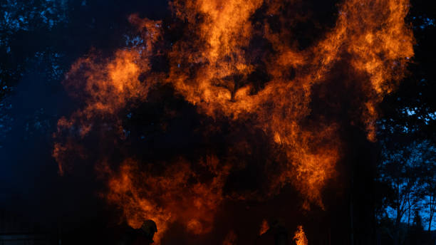 Firestorm close up, flaming fire burning. Smoke and fire billowing out