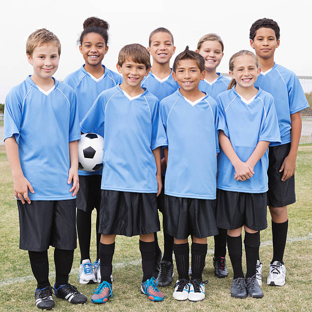 istock Happy kids' soccer team posing on field 175264955
