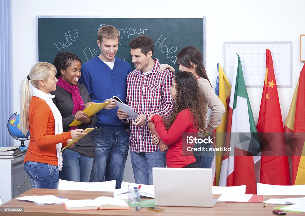 Language school. Group of students standing together in language class. Looking at camera and smiling.See more STUDENTS at LANGUAGE CLASS or FOREIGN LANGUAGE COURSE images. Click on image below for lightbox. 20-24 Years Stock Photo