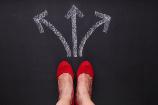 Unrecognizable woman standing in front of three arrow signs showing different waysSome other related images: