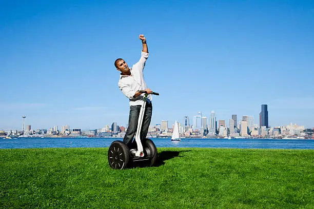 Photo of a young man enjoying a warm summer day on his personal transport device.