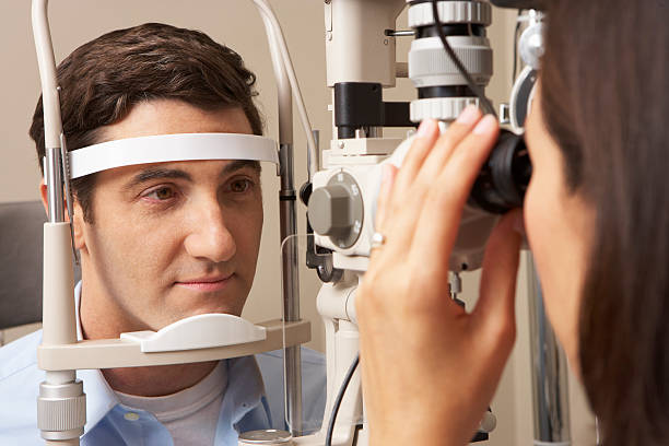 istock Female Optician Giving Man Eye Test 175265798