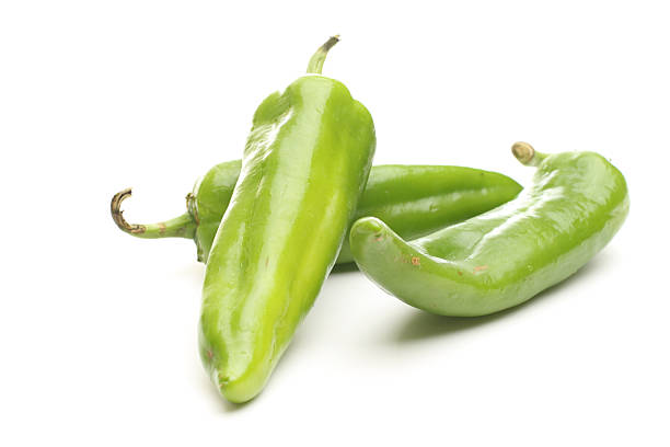 Three green chili peppers on white three anaheim peppers anaheim pepper photos stock pictures, royalty-free photos & images