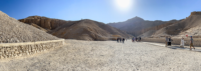 Luxor, Egypt - December 18, 2022: Groups of tourists explore the Valley of the Kings, a rocky gorge in Egypt where tombs for the pharaohs were built during the New Kingdom.
