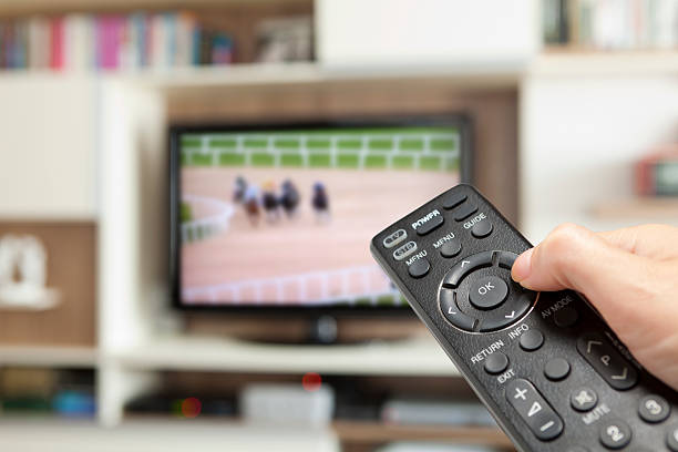 istock watching horse racing with TV remote control in hand 175269165