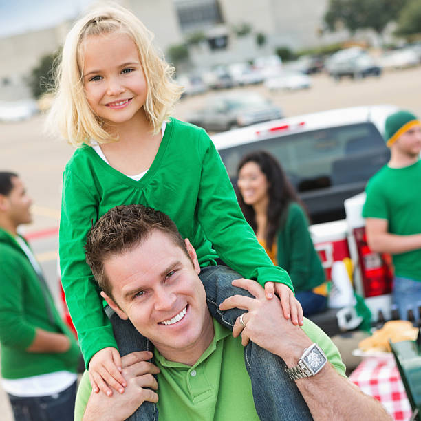Dad and daughter at college football stadium tailgate party Dad and daughter at college football stadium tailgate party. people family tailgate party outdoors stock pictures, royalty-free photos & images