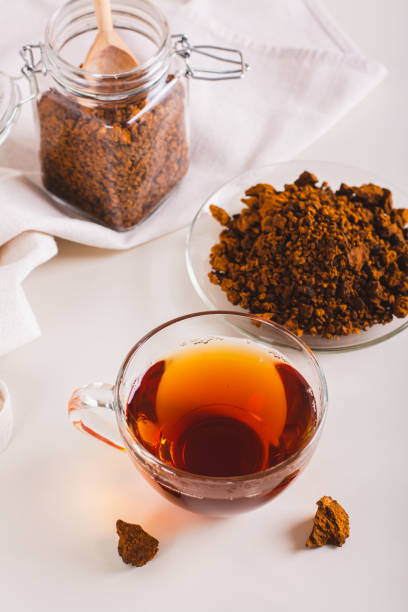 istock Healing tea from wild birch chaga mushroom in a cup on the table vertical view 1752698719