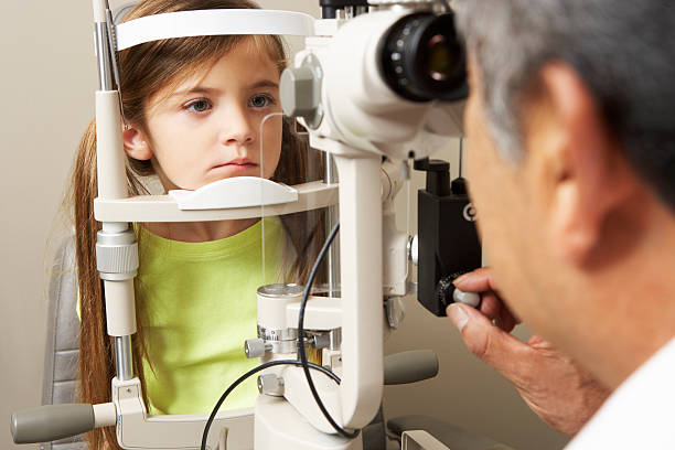 istock Optician In Surgery Giving Girl Eye Test 175270015