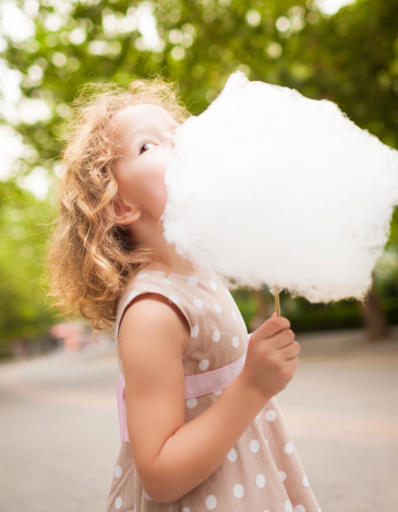 Picture of lovely girl eating cotton candy