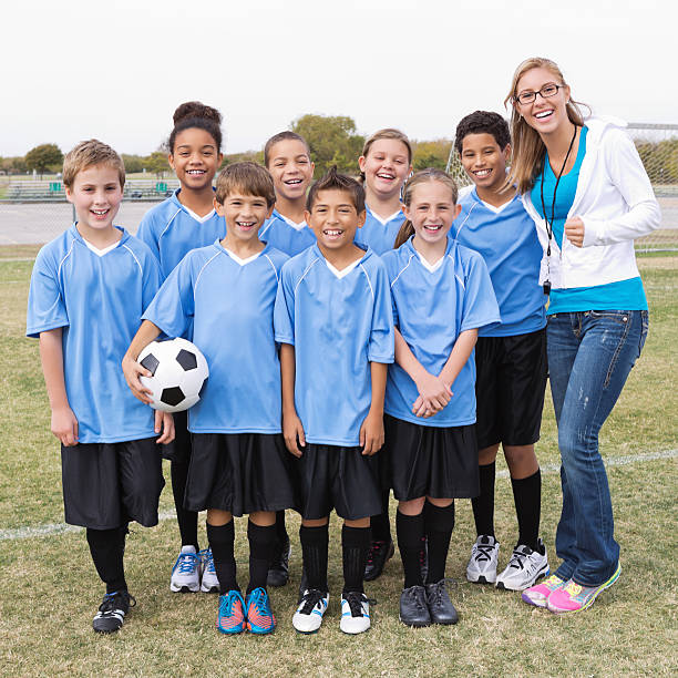 istock Youth league soccer team posing with coach after game 175270521