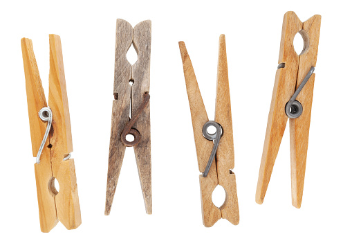 Set of vintage weathered wooden clothespins isolated on white