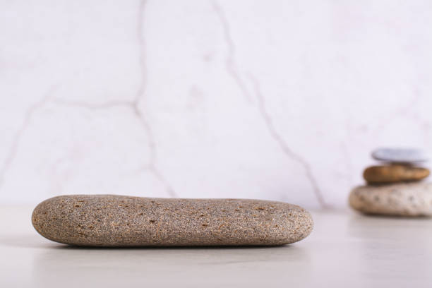 istock Pattern of smooth flat sea stone pedestal on table 1752708262